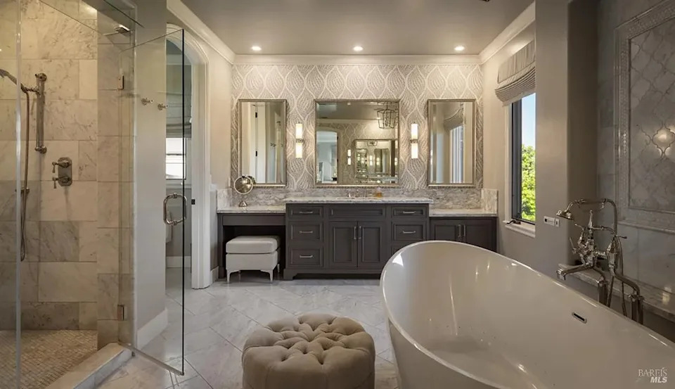 Spacious luxury master bathroom featuring a freestanding soaking tub, double vanity, and walk-in shower
