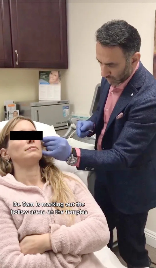 Dr. Sam marking a patient’s temples for treatment. Instagram/timelessskincarelaserclinic
