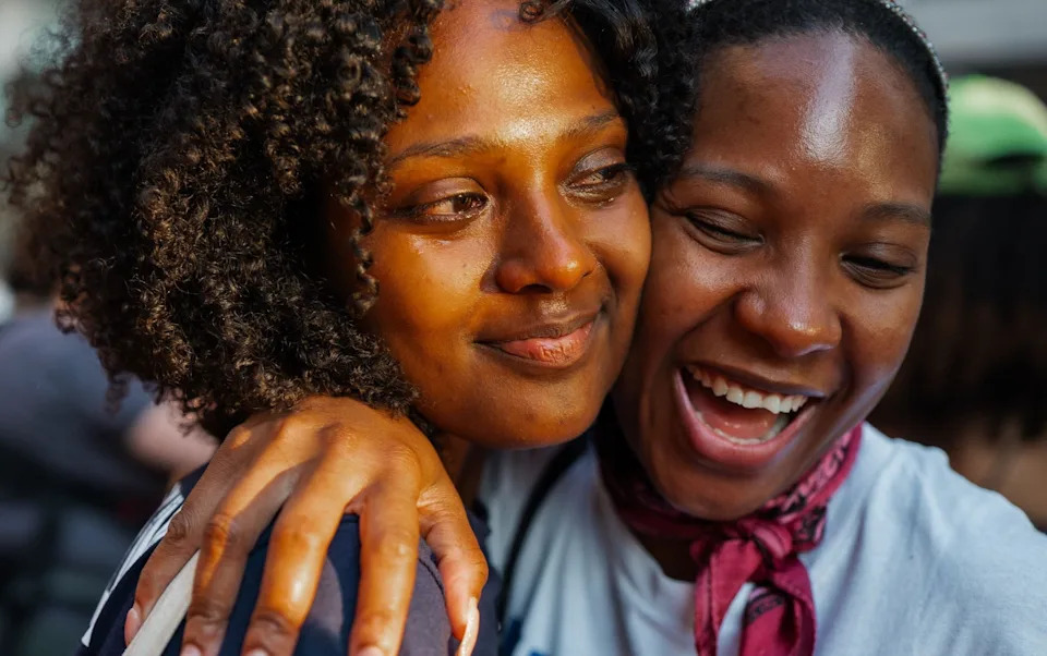People hug and cry after New York City's Rent Guidelines Board votes to freeze rents