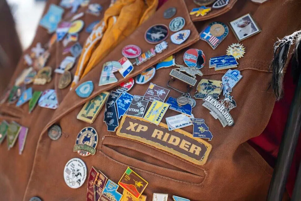Various pins are showcased on National Pony Express Association member Pam Dixon-Simons’ vest on Thursday, June 25, 2026, in Old Sacramento — the last stop of the group's annual ten-day ride across the United States reenacting the historic Pony Express.