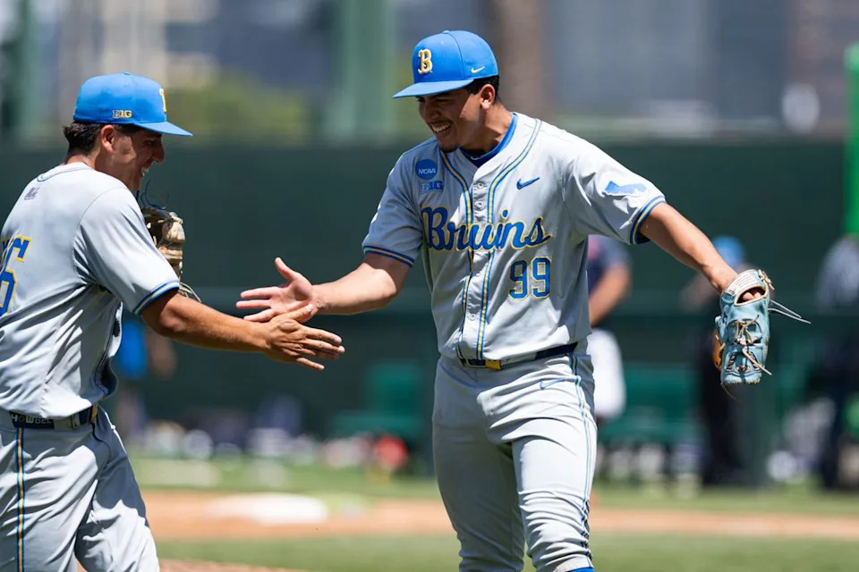 UCLA Bruins right-hand-pitcher Angel Cervantes (99) daps up with team mates during an NCAA regional championship elimination game between the Saint Mary's College Gaels and UCLA Bruins on May 31, 2026 at Jackie Robinson Stadium in Los Angeles Calif.