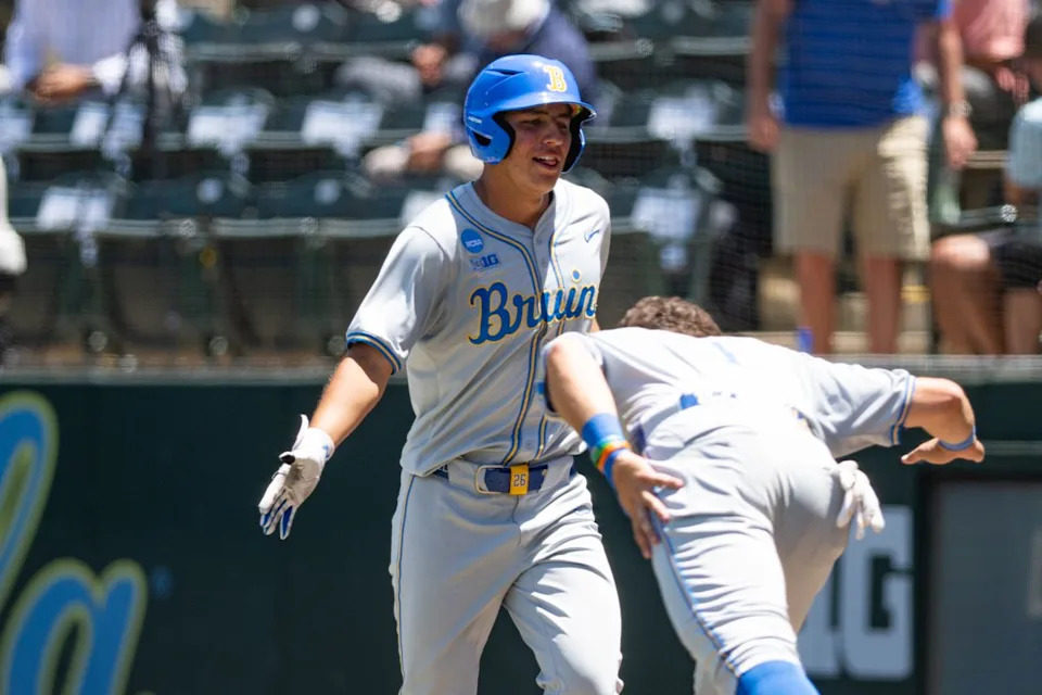 UCLA Bruins infielder Dominic Cadiz runs daps up Burins teammates after scoring a run during an NCAA regional championship elimination game between the Saint Mary's College Gaels and UCLA Bruins on May 31, 2026 at Jackie Robinson Stadium in Los Angeles Calif.