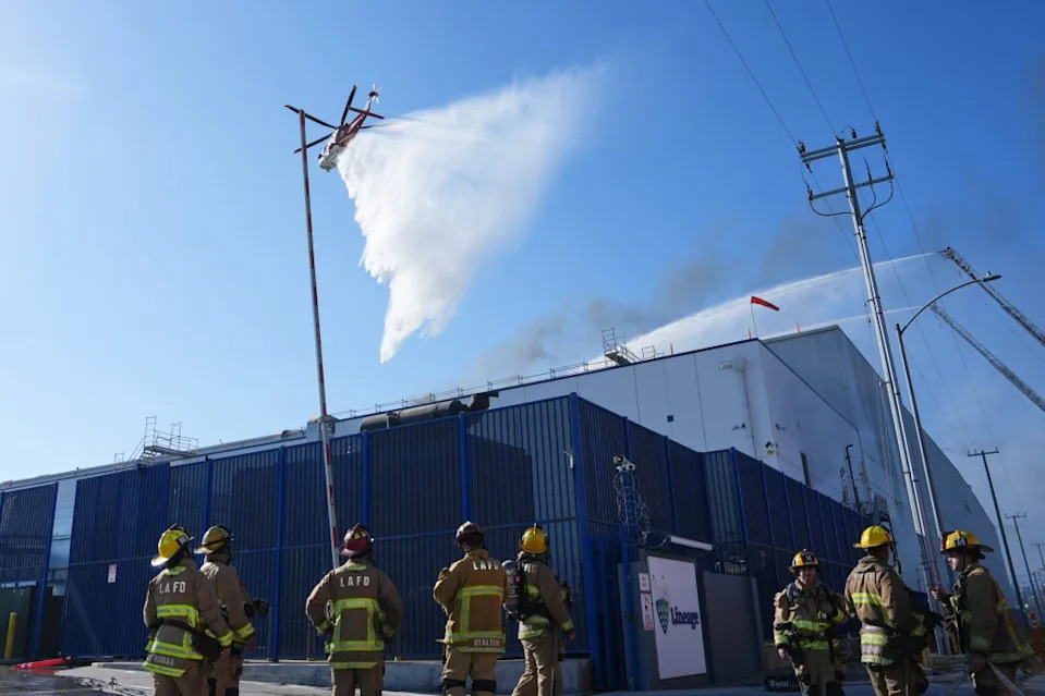 Water is dropped by helicopter at a warehouse fire in the Boyle Heights section of Los Angeles on Wednesday, June 17, 2026.