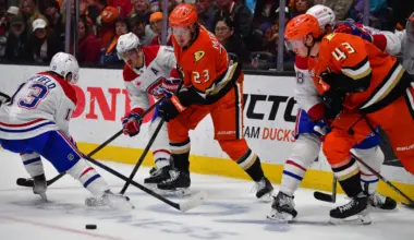 Anaheim, California, USA;Anaheim Ducks center Mason McTavish (23) and defenseman Drew Helleson (43) play for the puck against Montreal Canadiens right wing Cole Caufield (13) and right wing Brendan Gallagher (11) during the third period at Honda Center.