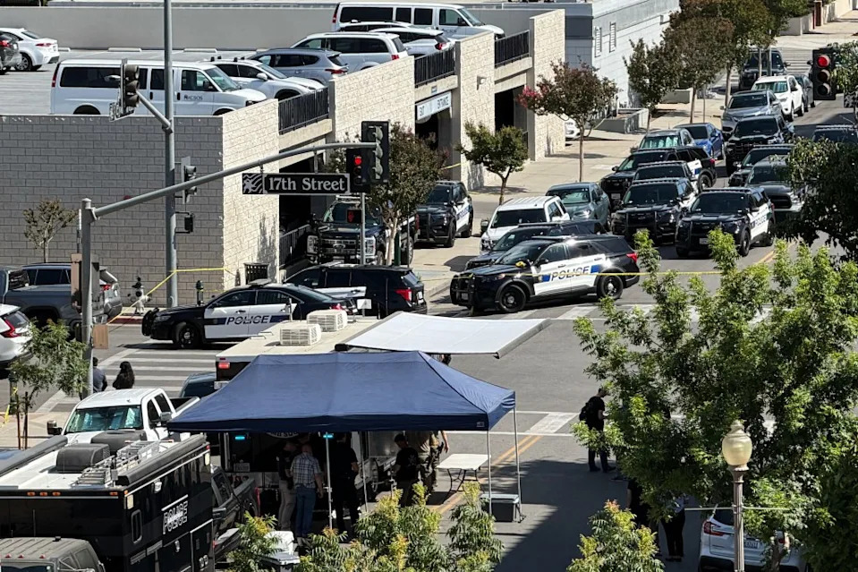 Multiple police vehicles are stationed outside the bank in Bakersfield, California.