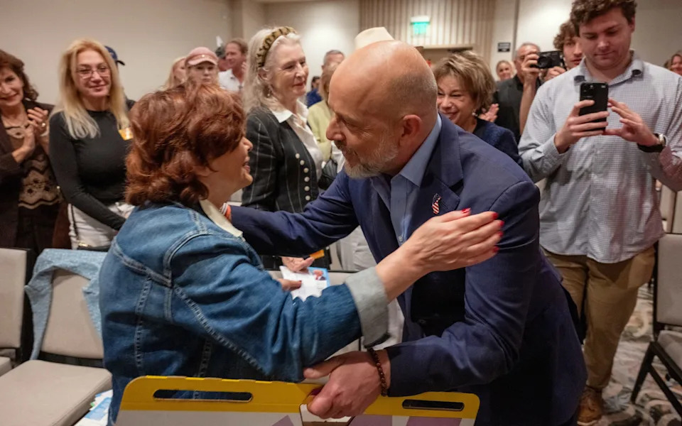 Mr Hilton embraces a supporter during a campaign event in Santa Monica