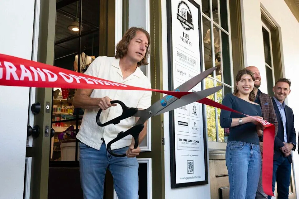 Stage Nine Entertainment/The Paperworks owner Troy Carlson cuts the ribbon to officially open The Paperworks in Old Sacramento on Friday.