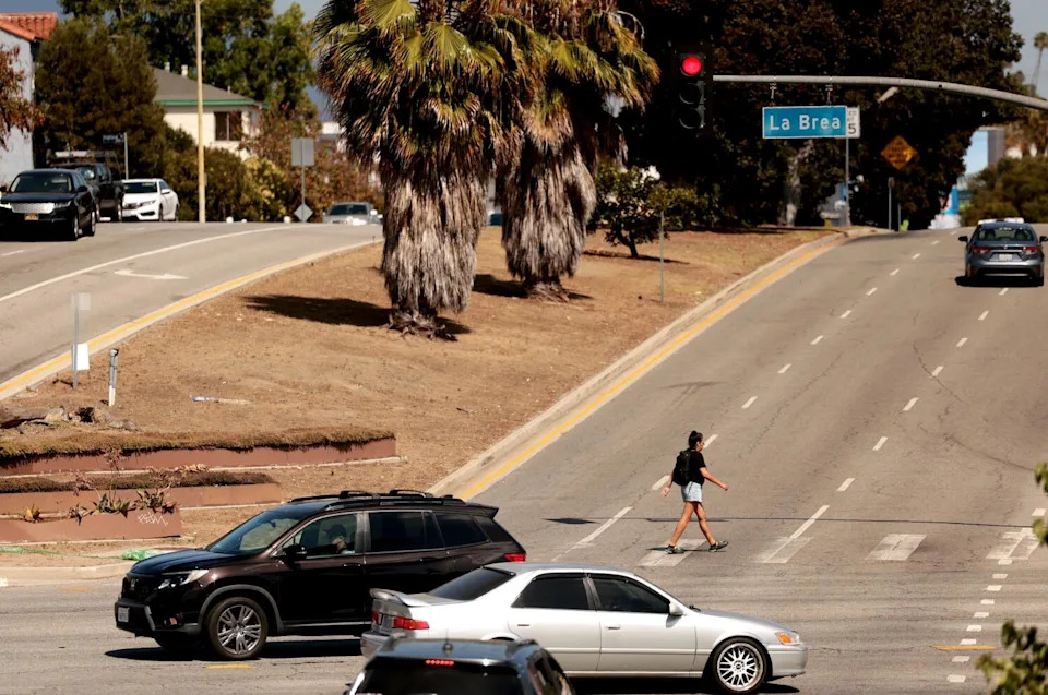 Traffic passes through the intersection of San Vicente Boulevard and La Brea.