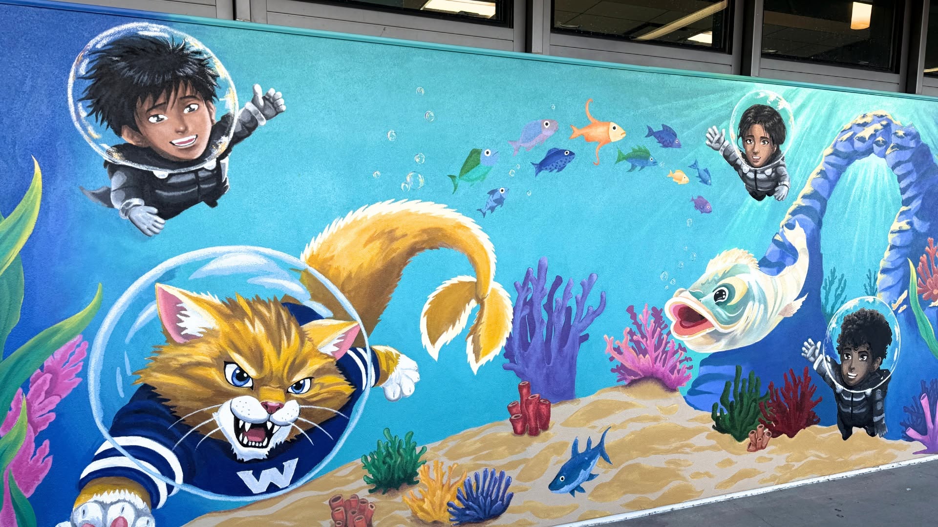 A mural at Warner Middle School depicts native plants and wildlife found in the Bolsa Chica Wetlands, along with students and the school’s Wildcat mascot.