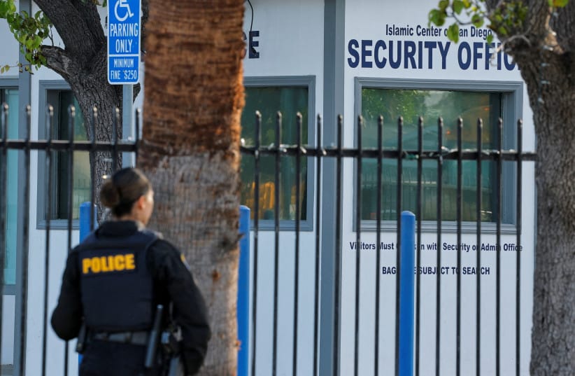 A police officer stands outside the Islamic Centre of San Diego the morning following a shooting, in San Diego, California, US, May 19, 2026.