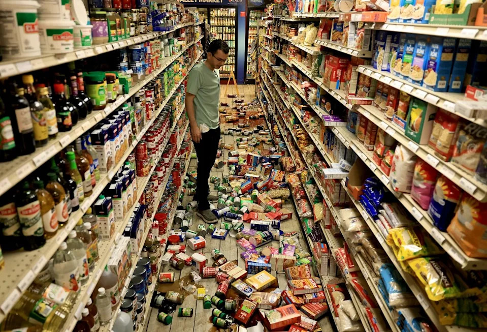 Chehada looks at items which fell off the shelves. Kent Porter/The Press Democrat via AP