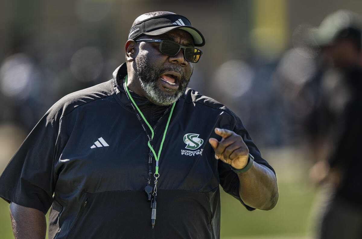 Sacramento State football coach Alonzo Carter calls out his defensive players during spring football drills on Thursday, March 19.