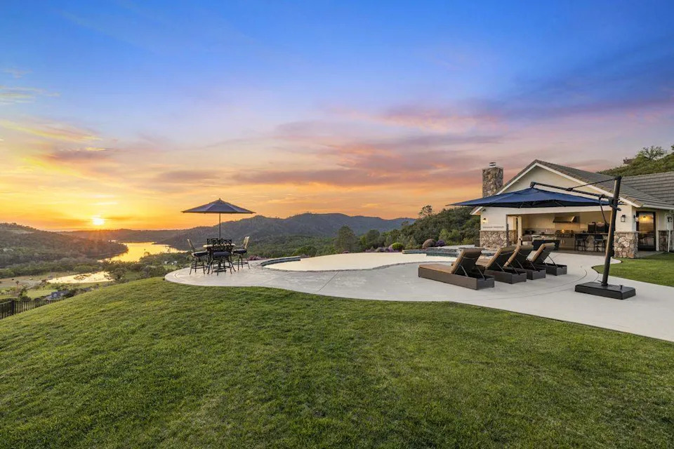 The remodeled El Dorado Hills residence spans 4,179 square feet with five bedrooms and 4.5 bathrooms, set on an 8.16-acre parcel designed to maximize lake and valley views.