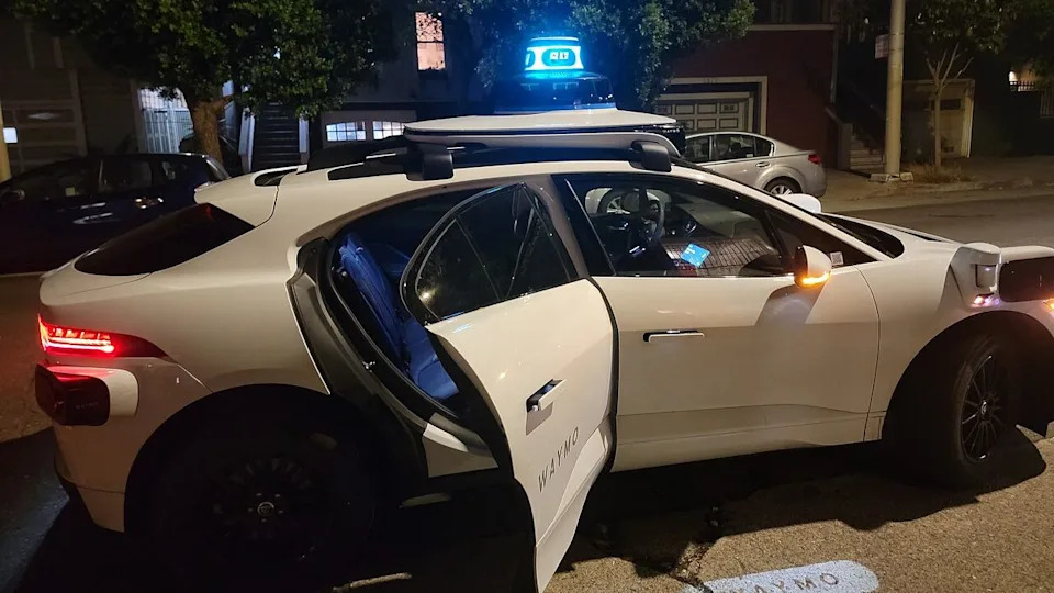 Waymo robotaxi with an open door.
