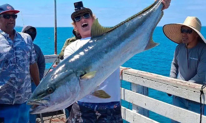 Brandon Dawson celebrate's yellowtail catch.
