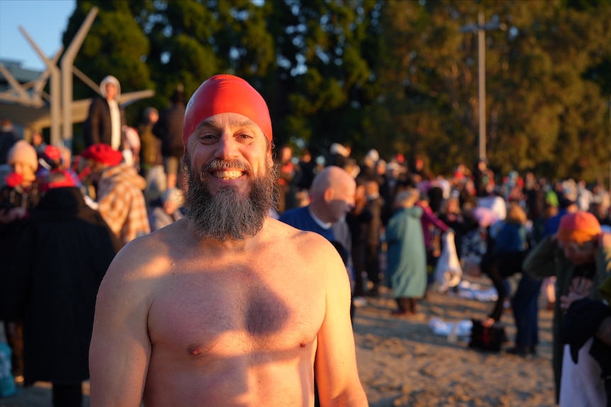 Dougal McLauchlan, wearing a red swimming cap, swam in the 2026 Dark Mofo Nude Solstice swim