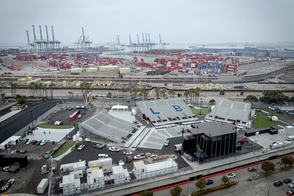 An amphitheater is seen from above with an oil field in the background.