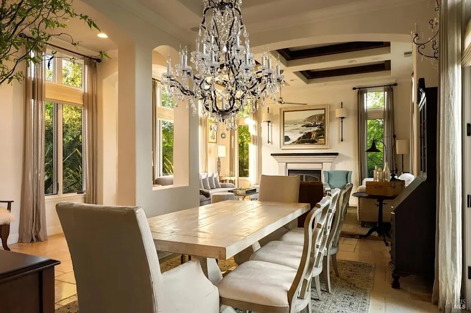 Sophisticated formal dining room featuring a wooden table and large crystal chandelier
