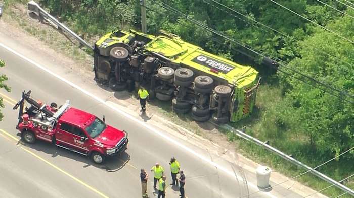 Priority Waste truck crashes into guardrail, tips over in Oakland Township