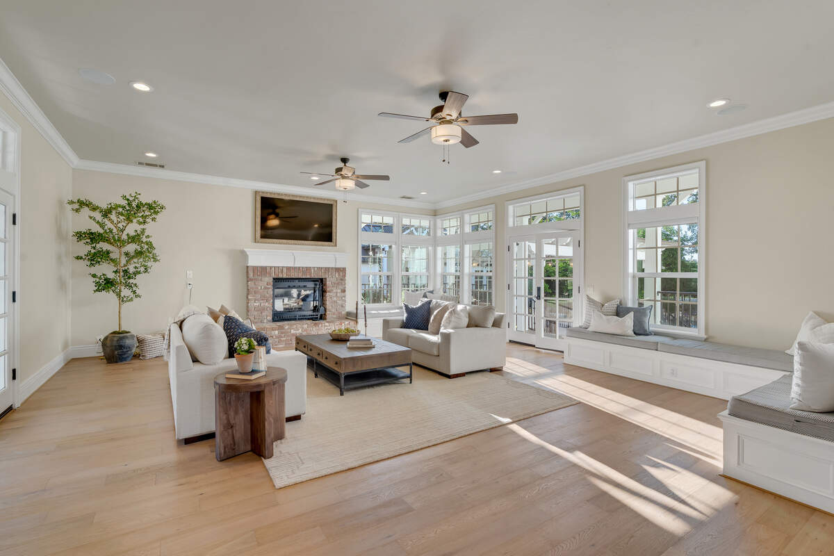 The main living room features double‑decker windows, wood floors and built‑in window seats with hidden storage that’s “the best used 350 square feet ever,” the listing agent said.