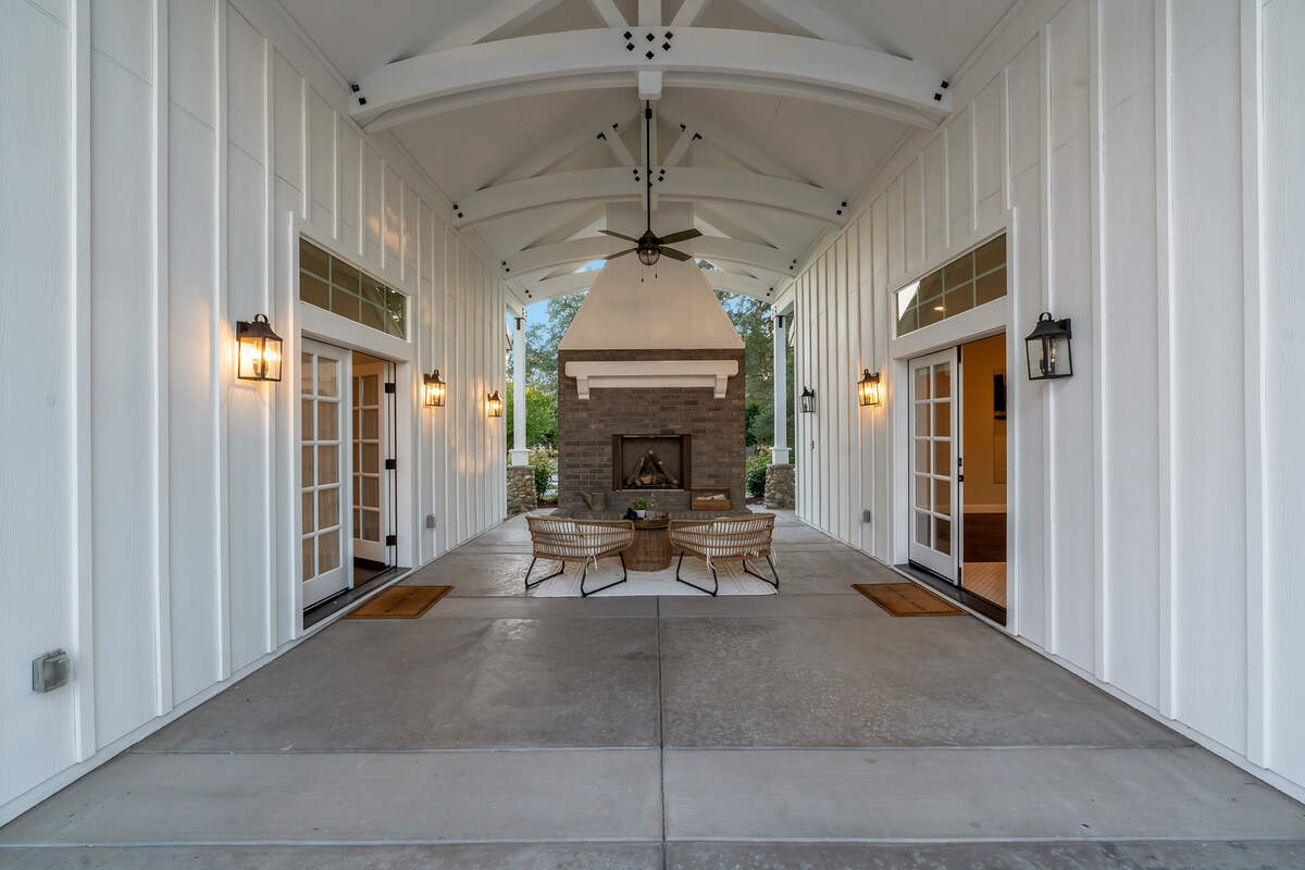 The porch and fireplace between the guest house and pool house is an inviting space.