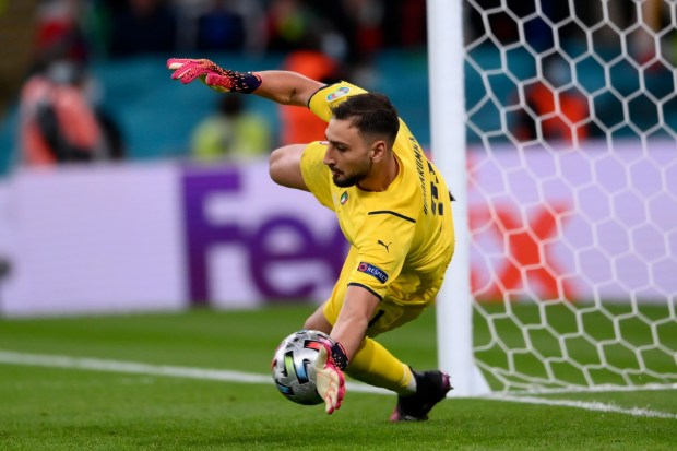 Italy's goalkeeper Gianluigi Donnarumma saves a shootout penalty during the Euro 2020 soccer semifinal match between Italy and Spain at Wembley stadium in London, Tuesday, July 6, 2021. Italy won and advances to the final. (Laurence Griffiths, Pool via AP)
