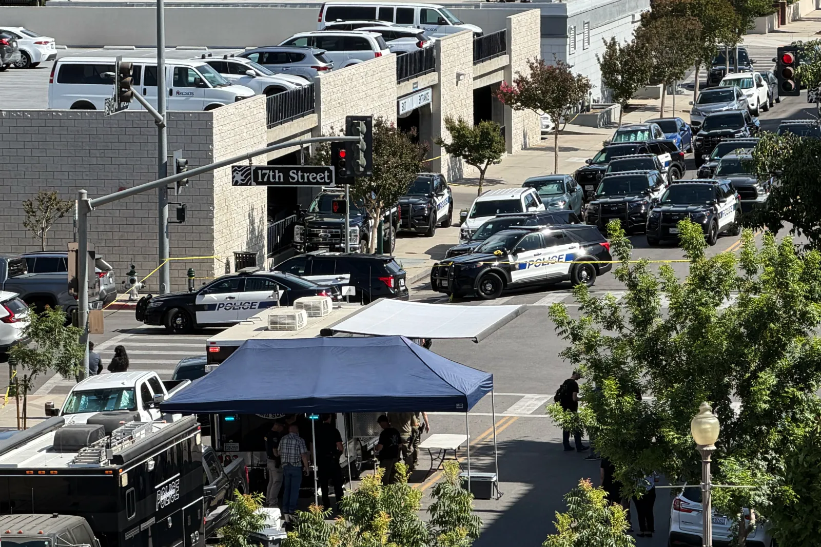 Multiple police vehicles are stationed outside the bank in Bakersfield, California.