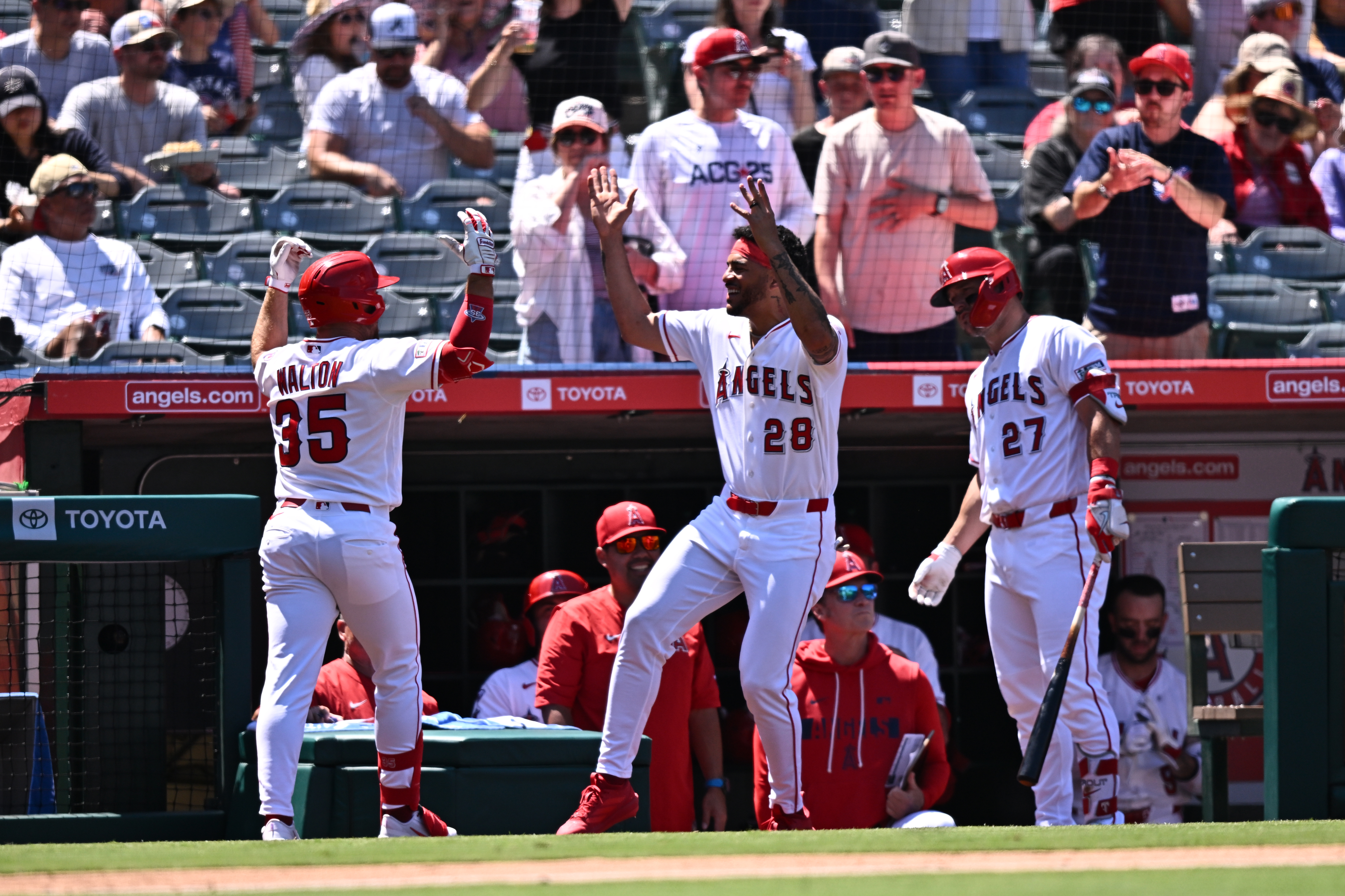 Angels’ Donovan Walton (35) is greeted by Jose Siri (28)...