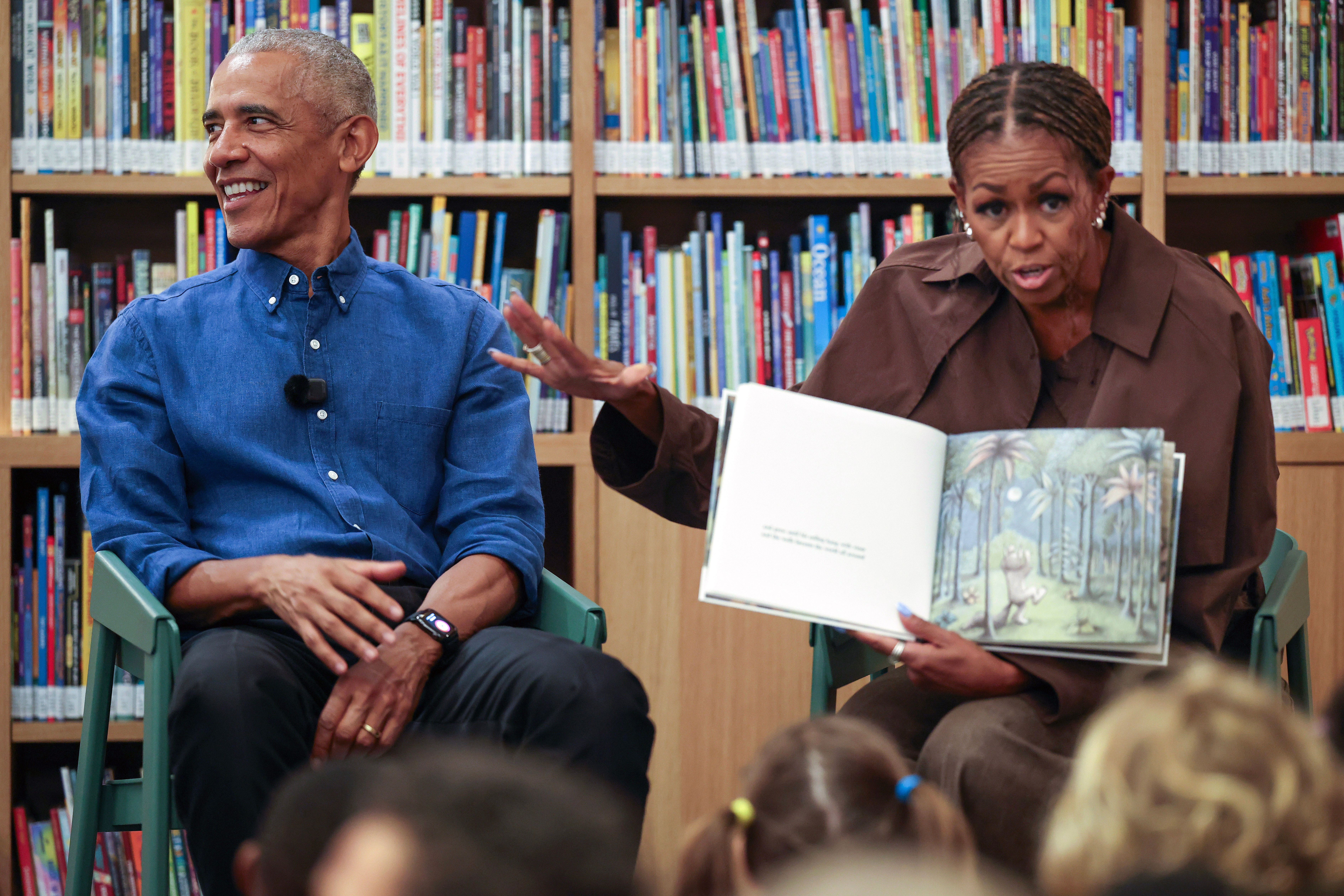 Former President Barack Obama, left, and former first lady Michelle...