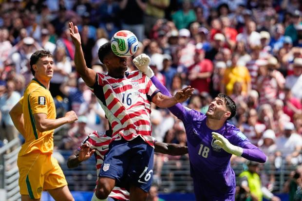 Australia goalkeeper Patrick Beach fails to stop a goal by United States' Alex Freeman, center, during the World Cup Group D soccer match between the United States and Australia in Seattle, Friday, June 19, 2026. (AP Photo/Lindsey Wasson)