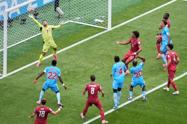 Portugal goalkeeper Diogo Costa fails to stop a headed goal by Congo's Yoane Wissa.