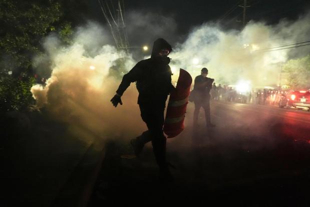 Anti-ICE protesters disperse during clashes with law enforcement officers outside the Delaney Hall detention center on Saturday, May 30, 2026, in Newark, N.J. (AP Photo/Angelina Katsanis)