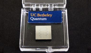 a clear plastic box labeled UC Berkeley Quantum and housing yellowish square