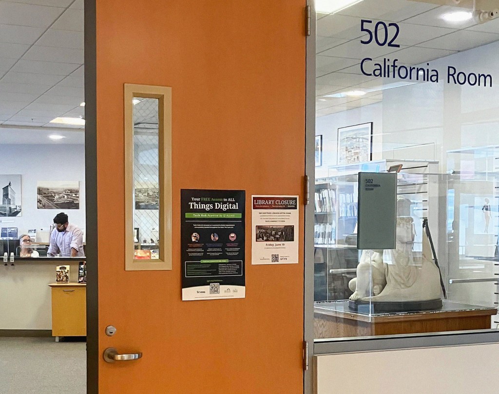 An orange door with posters announces a library closure and free digital access, leading to a room labeled "502 California Room" with a glass display case containing a statue.