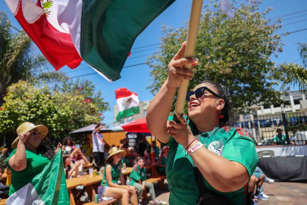 Teresa Sanchez, of Oakland, along with Mexican fans celebrate Mexico's second goal against South Africa at the Aloha Club in the Fruitvale district of Oakland, Calif., on Thursday, June 11, 2026, during a live broadcast of the World Cup inaugural match in Mexico City. (Ray Chavez/Bay Area News Group)
