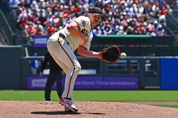 San Francisco Giants pitcher Logan Webb (62) catches a hit by Chicago Cubs' Ian Happ (8) in the first innning of their MLB game at Oracle Park in San Francisco, Calif., on Sunday, June 14, 2026. Webb would throw to second base to complete the double play. (Jose Carlos Fajardo/Bay Area News Group)