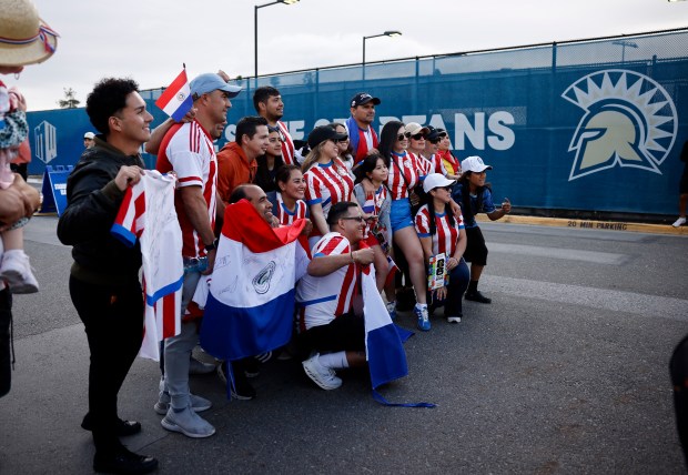 Soccer fans, some wearing Paraguay's soccer jersey, pose for a photograph after Paraguay's national soccer team trained at San Jose State University's Spartan Soccer Complex in preparation for the FIFA World Cup in San Jose, Calif., on Monday, June 8, 2026. (Nhat V. Meyer/Bay Area News Group)