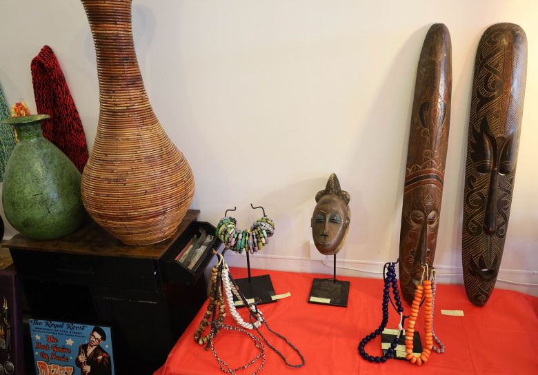 African masks and other crafts are displayed on a table