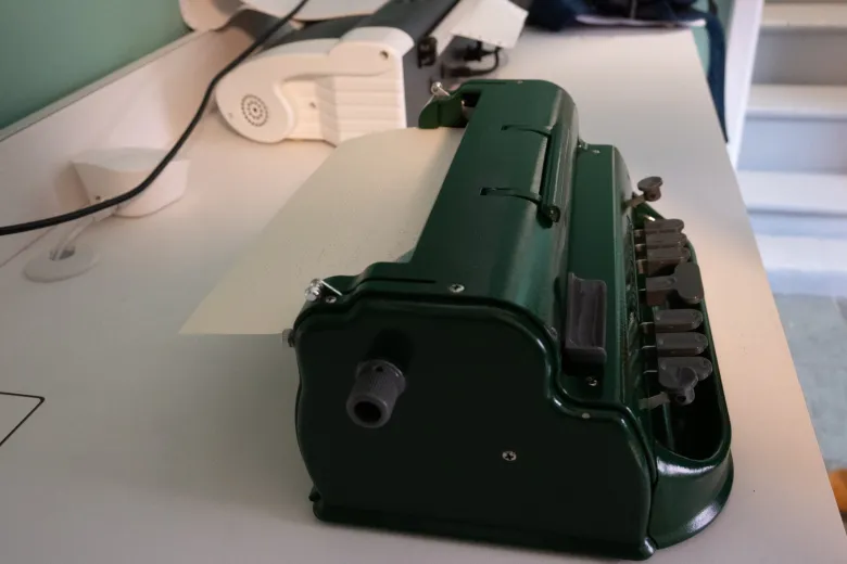 Dark green Brailler on top of desk
