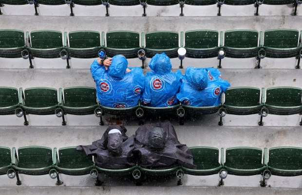 Chicago Cubs fans wait out a rain delay before the scheduled start of a game between the Cubs and the San Francisco Giants at Wrigley Field in Chicago on June 5, 2026. (Chris Sweda/Chicago Tribune)