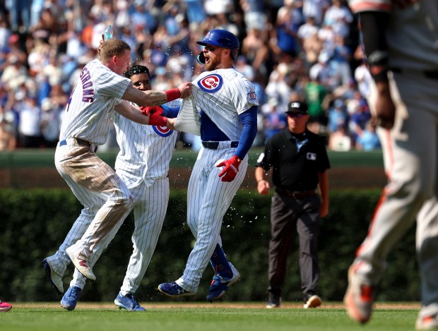 Cubs first baseman Michael Busch, right, and center fielder Pete Crow-Armstrong celebrate after Busch's single led to a fielding error by the Giants that allowed Dansby Swanson to score the winning run in the 10th inning Saturday, June 6, 2026, at Wrigley Field. (Chris Sweda/Chicago Tribune)
