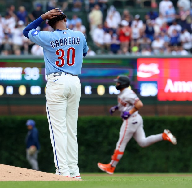 Chicago Cubs starting pitcher Edward Cabrera (30) stands on the infield as San Francisco Giants shortstop Willy Adames (background) rounds the bases after Adames hit a two-run home run in the first inning of a game at Wrigley Field in Chicago on June 5, 2026. (Chris Sweda/Chicago Tribune)