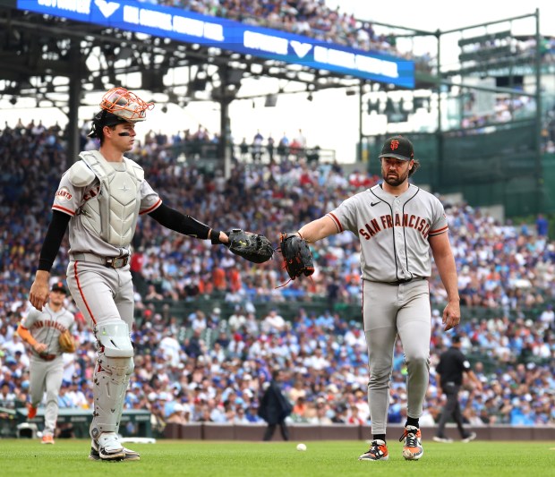 San Francisco Giants catcher Daniel Susac (left) and starting pitcher Robbie Ray congratulate one another after shutting down the Chicago Cubs in the first inning of a game at Wrigley Field in Chicago on June 5, 2026. (Chris Sweda/Chicago Tribune)