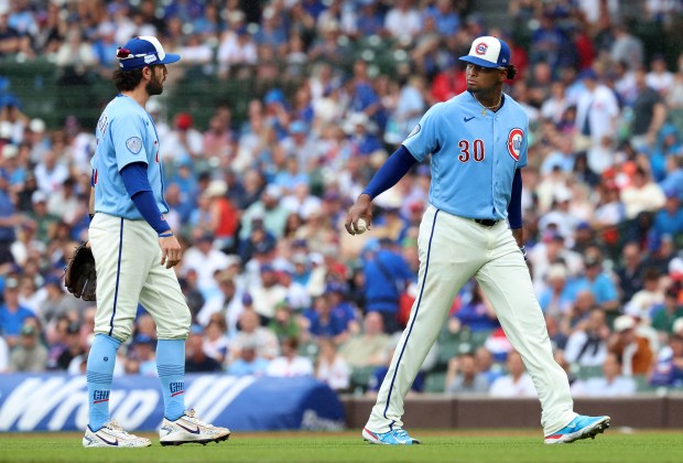 Chicago Cubs starting pitcher Edward Cabrera (right) looks back toward shortstop Dansby Swanson after an infield single by San Francisco Giants designated hitter Bryce Eldridge in the fourth inning of a game at Wrigley Field in Chicago on June 5, 2026. (Chris Sweda/Chicago Tribune)