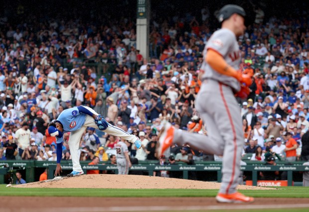 Chicago Cubs starting pitcher Edward Cabrera leans over on the mound as San Francisco Giants third baseman Matt Chapman rounds the bases after Chapman hit a grand slam in the fourth inning of a game at Wrigley Field in Chicago on June 5, 2026. (Chris Sweda/Chicago Tribune)