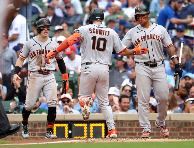 San Francisco Giants left fielder Casey Schmitt (10) is congratulated by teammate Rafael Devers (right) after Schmitt hit a two-run home run in the fourth inning of a game against the Chicago Cubs at Wrigley Field in Chicago on June 5, 2026. (Chris Sweda/Chicago Tribune)