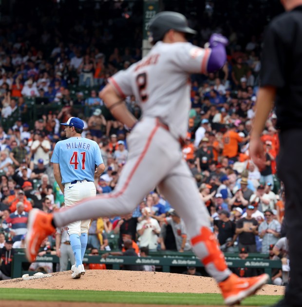 Chicago Cubs relief pitcher Hoby Milner (41) stands on the mound after giving up a two-run home run to San Francisco Giants shortstop Willy Adames (foreground) in the sixth inning of a game at Wrigley Field in Chicago on June 5, 2026. (Chris Sweda/Chicago Tribune)