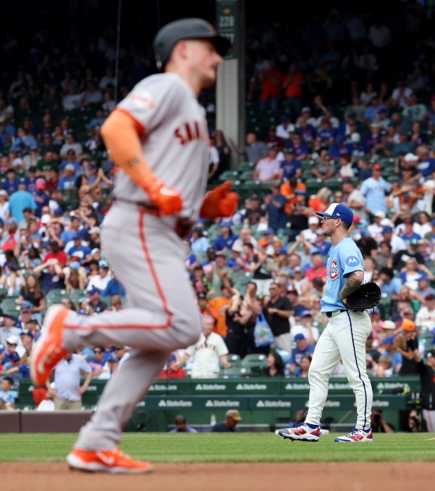 Chicago Cubs relief pitcher Ethan Roberts stands on the infield as San Francisco Giants third baseman Matt Chapman rounds the bases after hitting a three-run home run in the sixth inning of a game at Wrigley Field in Chicago on June 5, 2026. (Chris Sweda/Chicago Tribune)