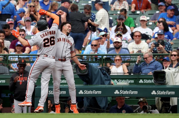 San Francisco Giants third baseman Matt Chapman (26) is congratulated by teammate Willy Adames (right) after Chapman hit a three-run home run in the sixth inning of a game against the Chicago Cubs at Wrigley Field in Chicago on June 5, 2026. (Chris Sweda/Chicago Tribune)
