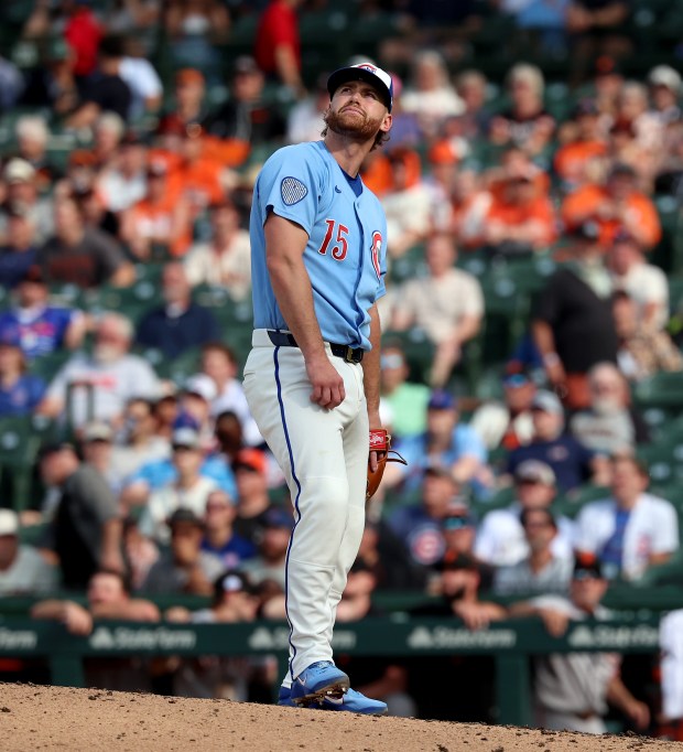Chicago Cubs catcher Carson Kelly (15), working in a role as a relief pitcher, watches the flight of a solo home hit by San Francisco Giants left fielder Casey Schmitt in the ninth inning of a game at Wrigley Field in Chicago on June 5, 2026. (Chris Sweda/Chicago Tribune)